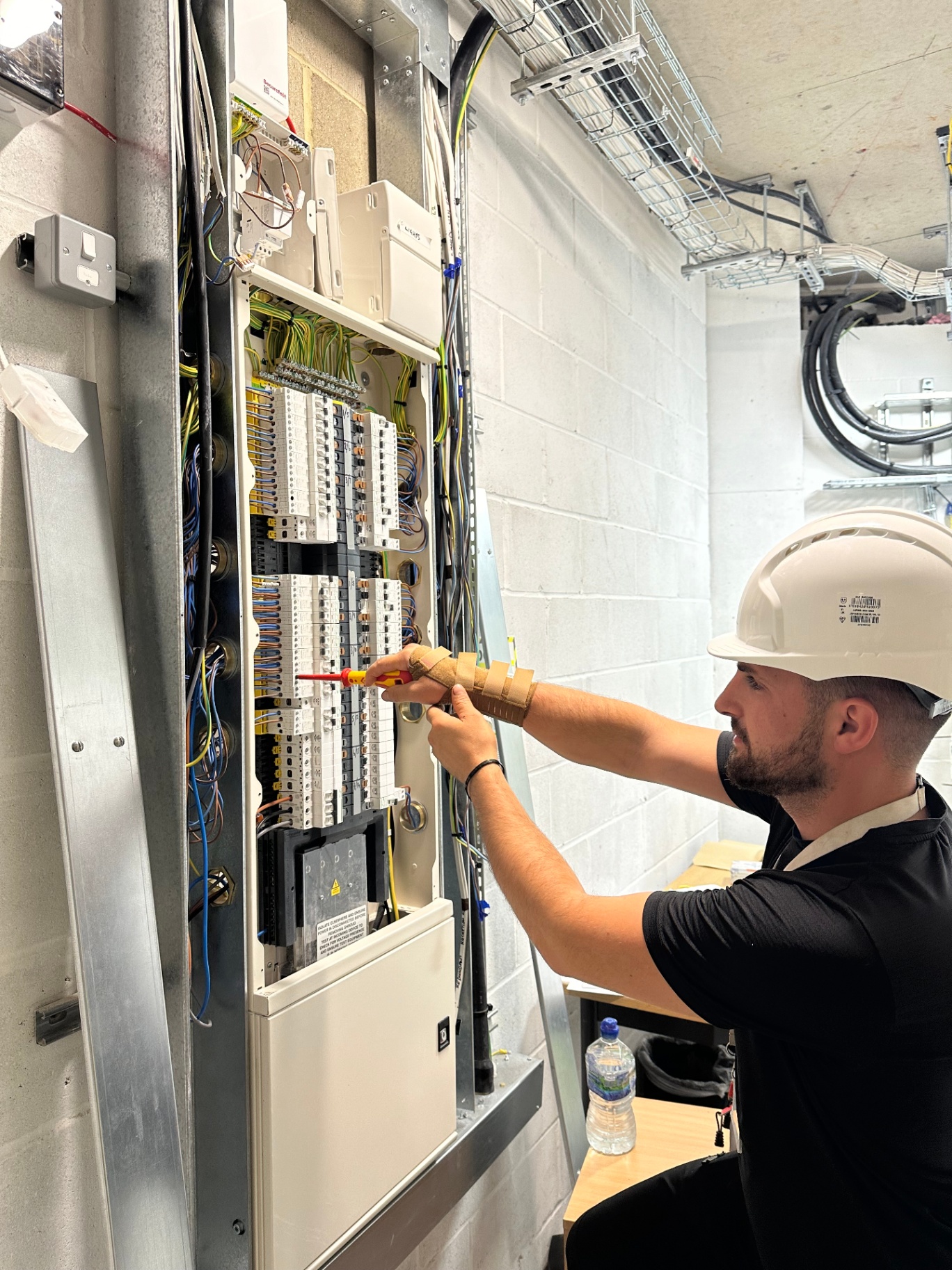 Qualified London electrician working on consumer unit wiring